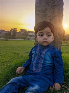 stylish kid sitting in sunset