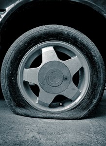 Car wheel puncture on road