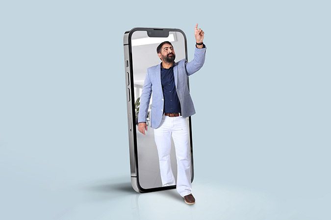 Middle aged man standing with mobile phone and pointing to sky