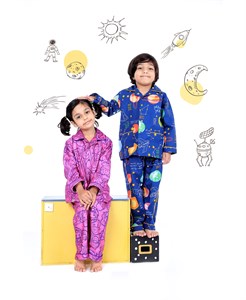two kids in a space theme night suit and background