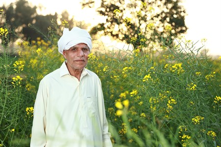 Old man with fields as background
