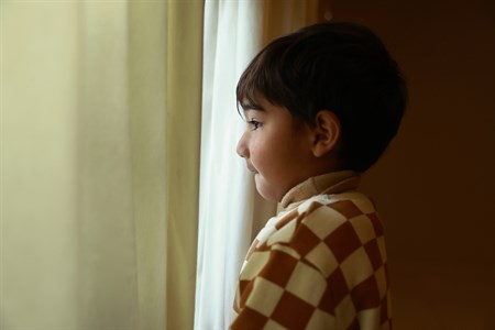 Kid looking outside the window
