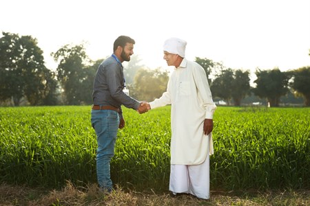 Banker shaking hand with a farmer