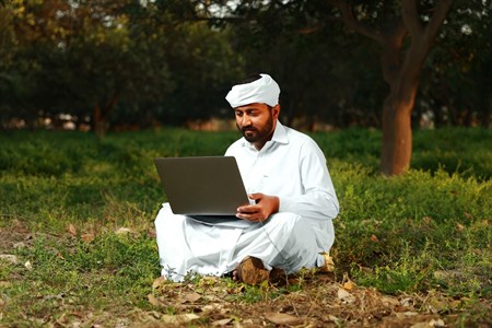 Man in traditional clothes using laptop