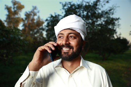 Man in traditional clothes talking on a mobile phone