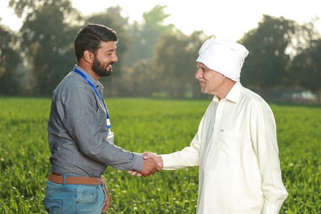 Banker shaking hand with a farmer