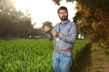 Man looking away while holding crops
