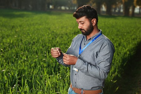 Man looking  holding crops