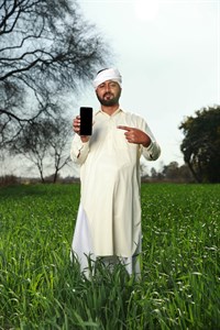 Man in traditional clothes pointing at mobile screen