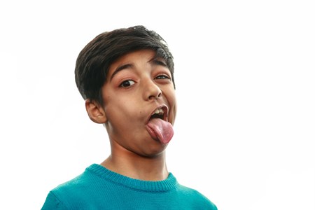 Kid making a funny face with tongue out
