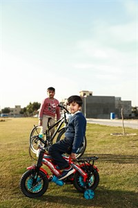 Kids on bicycle in playground