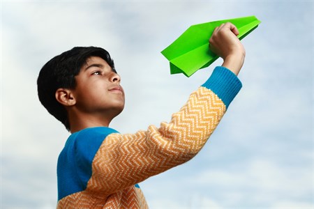 Kid holding a paper plane