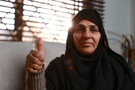 Woman in hijab giving thumbs up