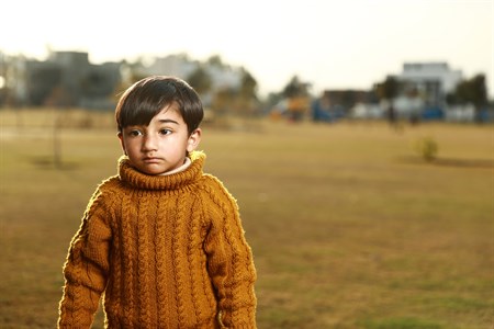 Kid with a serious face in park