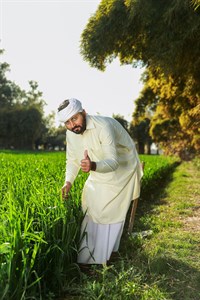 Farmer giving a thumbs up while checking crops