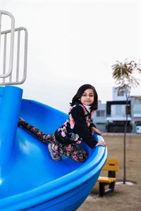 Playful little girl taking slide