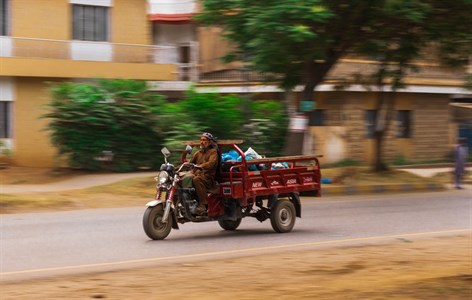 a man going on motorcycle rikshaw