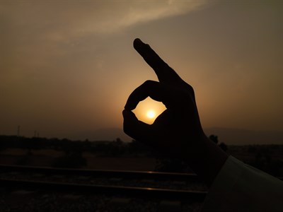 Hand capturing Sunrise