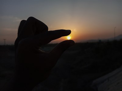 Hand Capturing Sunrise