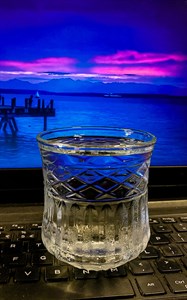 Water glass on laptop