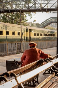 Worker sitting on a bench at railway station