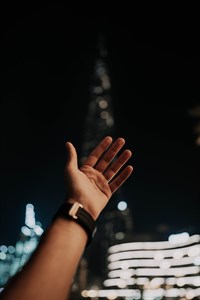Hand reaching Burj Khalifa Dubai