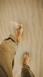 Feet on beach sand