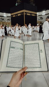 Holding Holy Quran in Kaaba Saudi Arabia