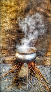 Cooking Meat in Clay Pot in a Village Kitchen