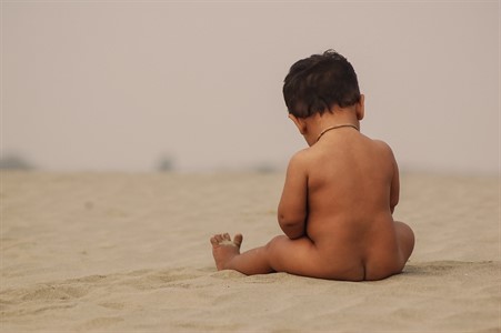 Little Kid playing on Cold Sand